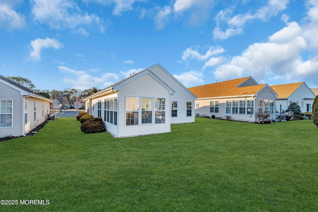 back of house featuring a lawn