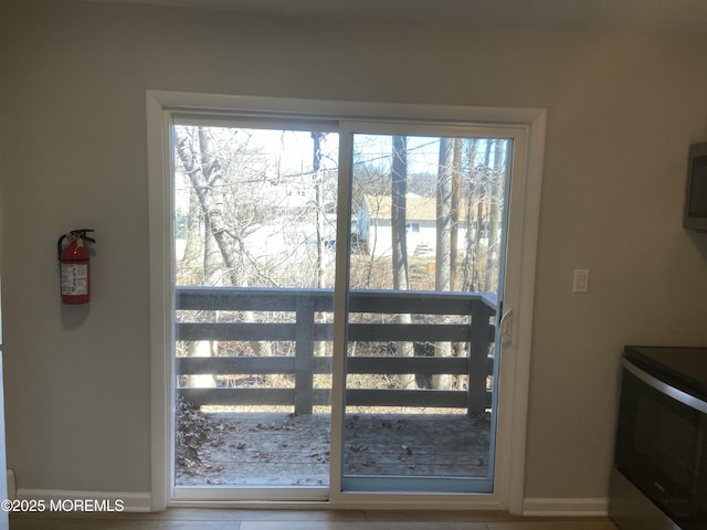 doorway featuring baseboards