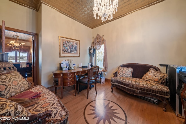 office with crown molding, a notable chandelier, wood finished floors, and an ornate ceiling