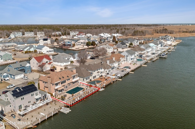 drone / aerial view with a residential view and a water view