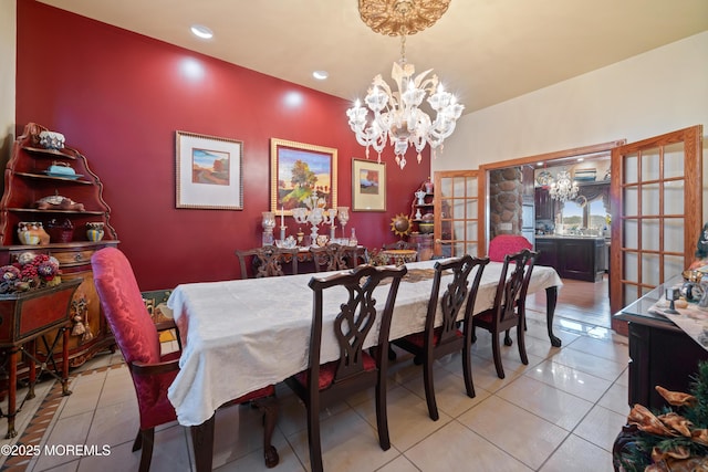 dining room featuring light tile patterned floors and a chandelier