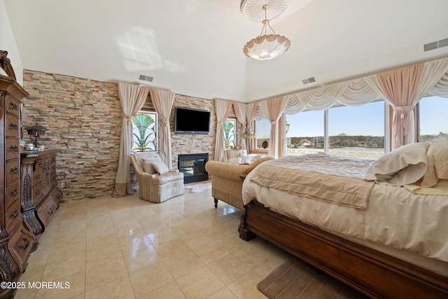 bedroom featuring access to outside, a fireplace, and visible vents