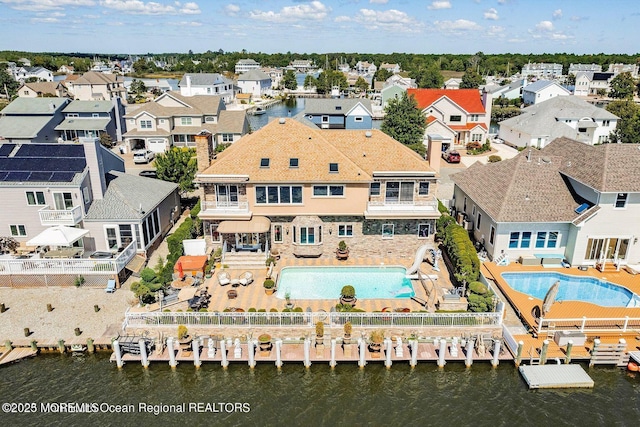 birds eye view of property with a residential view and a water view