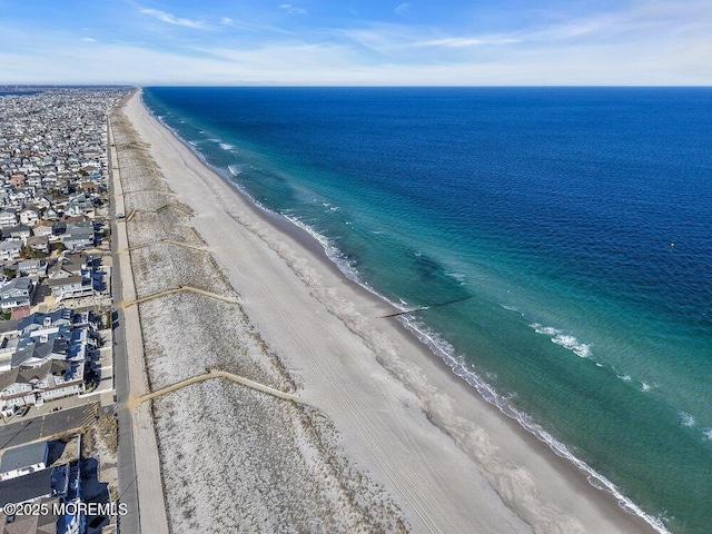 birds eye view of property with a beach view and a water view