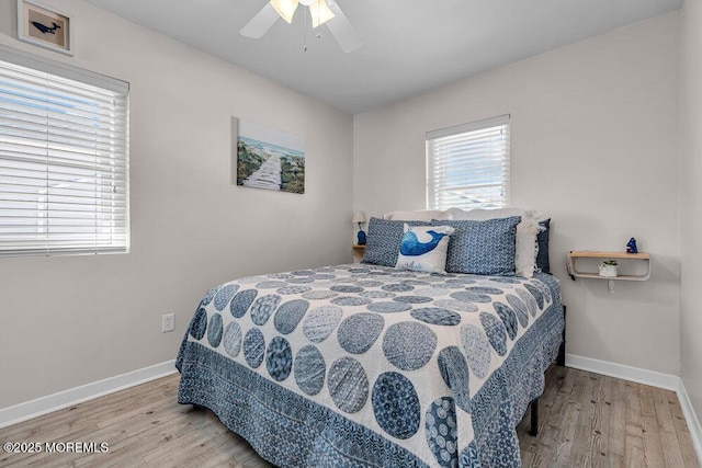 bedroom with a ceiling fan, baseboards, and wood finished floors