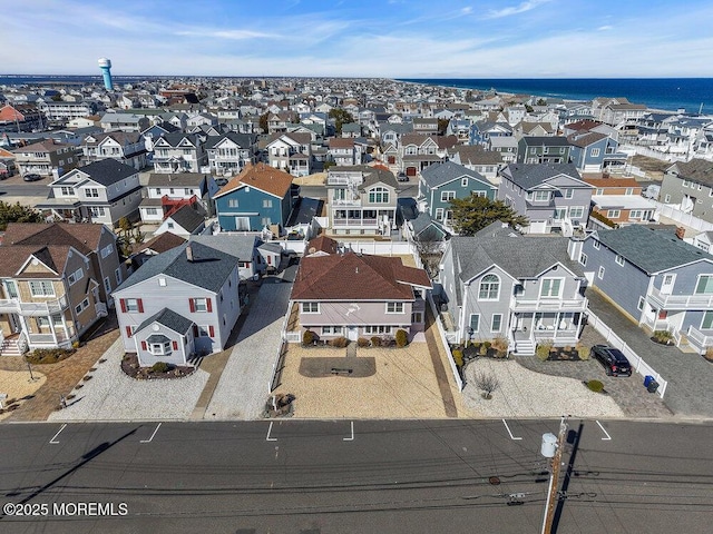 drone / aerial view featuring a residential view and a water view