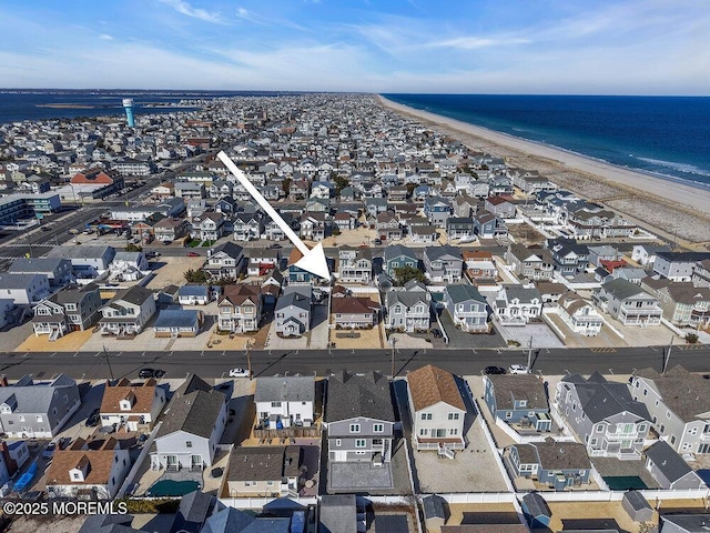 drone / aerial view with a water view, a residential view, and a view of the beach