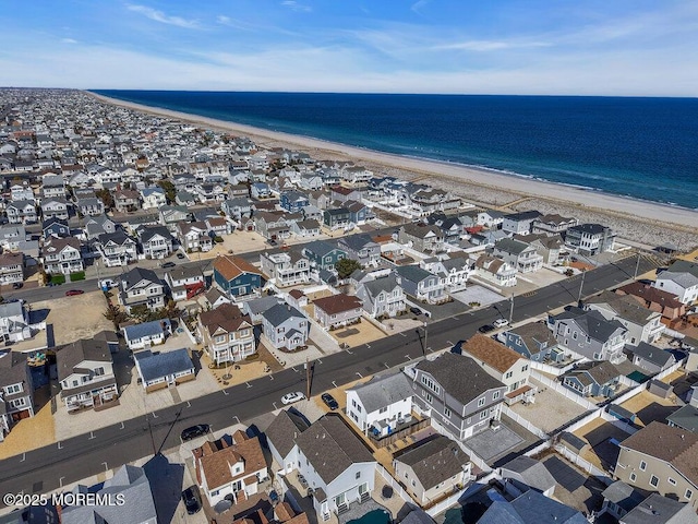 aerial view featuring a water view, a residential view, and a view of the beach