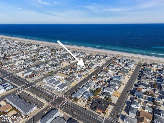 birds eye view of property featuring a water view and a view of the beach