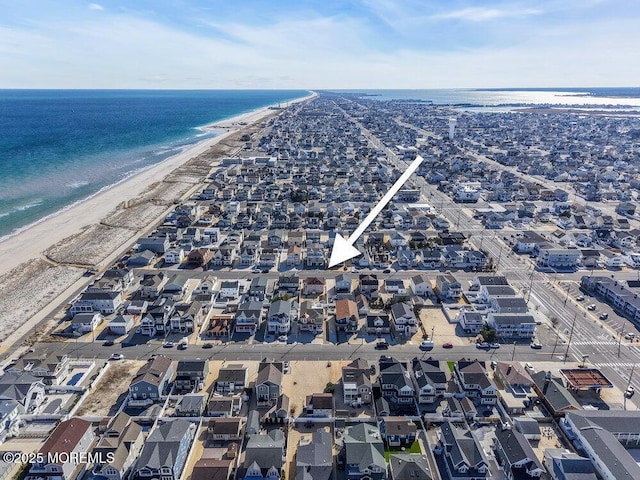 birds eye view of property featuring a water view, a residential view, and a view of the beach