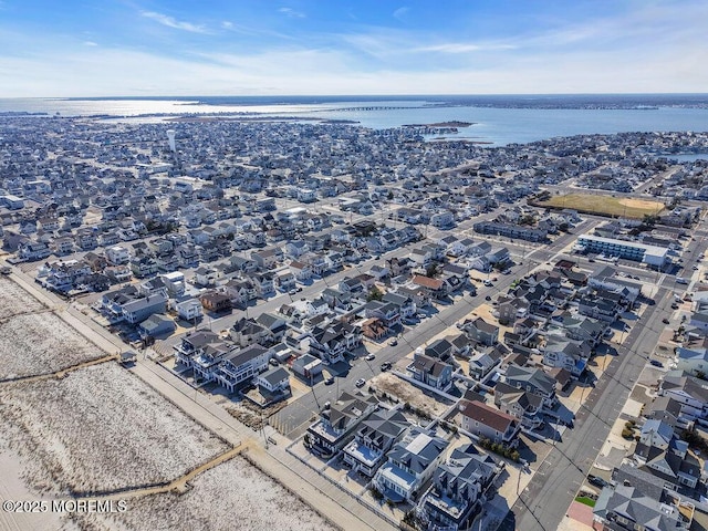 drone / aerial view with a water view and a residential view