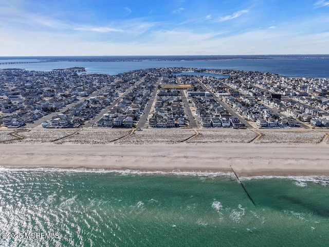 bird's eye view featuring a view of the beach and a water view