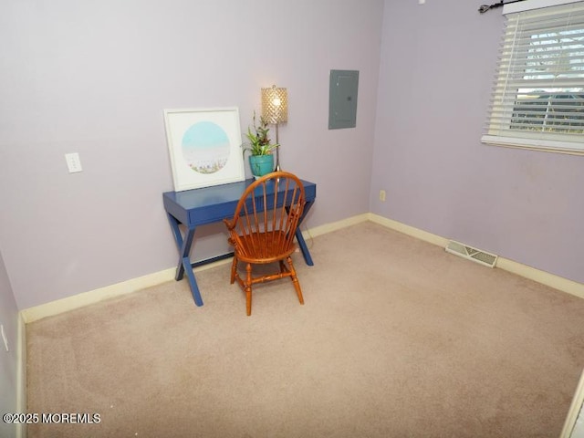 carpeted office space with baseboards, electric panel, and visible vents