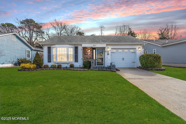 ranch-style house with a garage, driveway, a shingled roof, and a front lawn