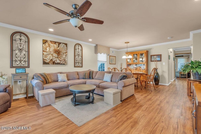 living room featuring ornamental molding, a ceiling fan, recessed lighting, light wood-style floors, and baseboards