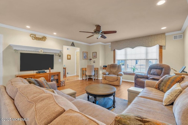 living area with visible vents, a ceiling fan, wood finished floors, recessed lighting, and crown molding