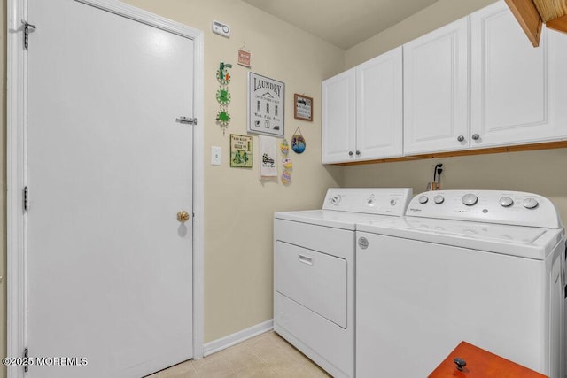 washroom with washer and dryer, baseboards, and cabinet space