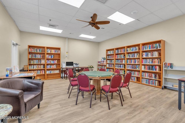 dining space featuring visible vents, a paneled ceiling, wood finished floors, and a ceiling fan