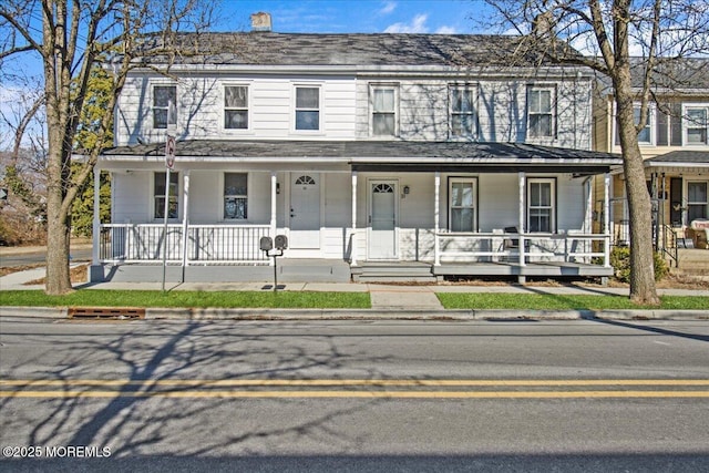 townhome / multi-family property featuring covered porch