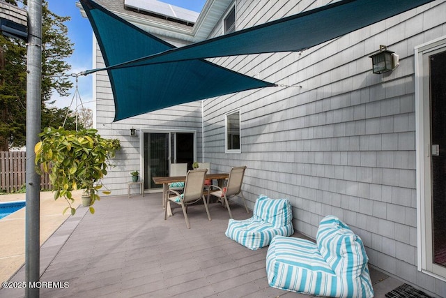 view of patio / terrace featuring outdoor dining area, visible vents, fence, and a wooden deck