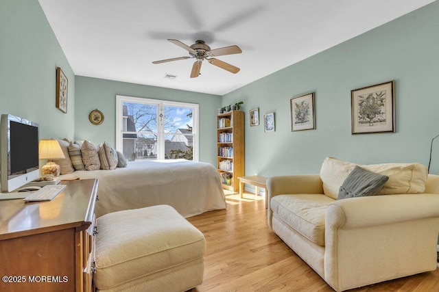 bedroom with visible vents, light wood-type flooring, and a ceiling fan