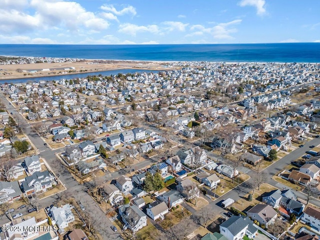 aerial view with a water view, a view of the beach, and a residential view