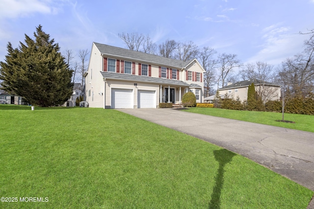 view of front of property featuring a garage, a front yard, and driveway