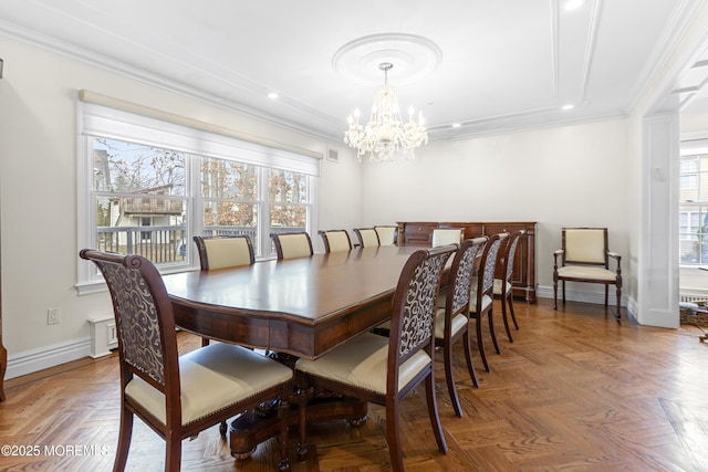 dining area with an inviting chandelier, baseboards, visible vents, and ornamental molding