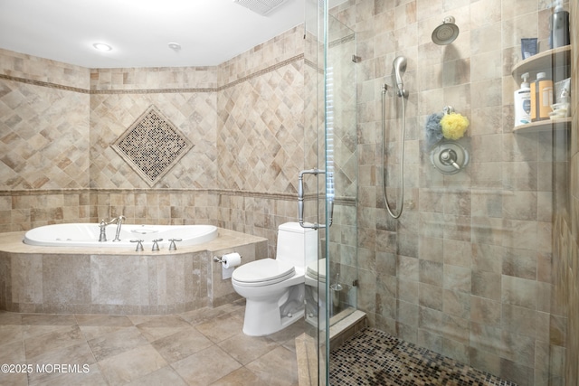 bathroom with tile walls, toilet, a shower stall, tile patterned flooring, and a bath