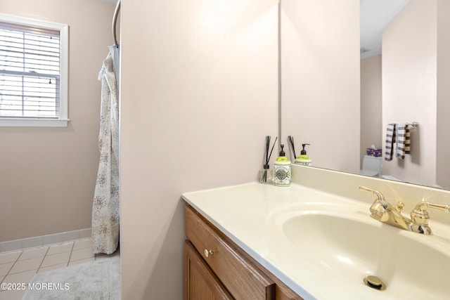 full bathroom with vanity, baseboards, and tile patterned floors