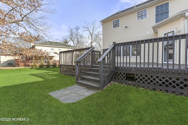 rear view of property with a deck and a yard