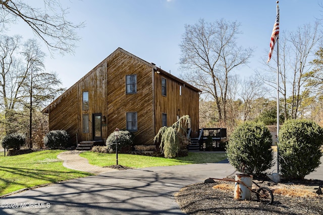 view of property exterior featuring a lawn