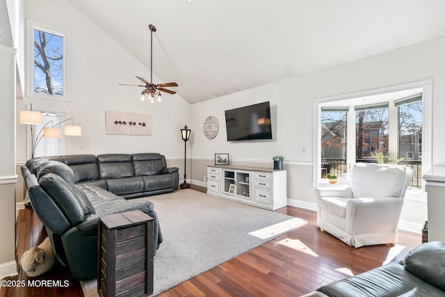 living area with ceiling fan, high vaulted ceiling, wood finished floors, and baseboards