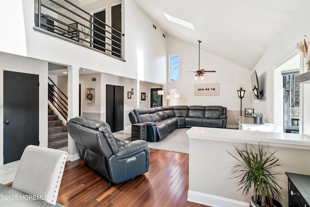 living room with wood-type flooring, stairs, and a wealth of natural light