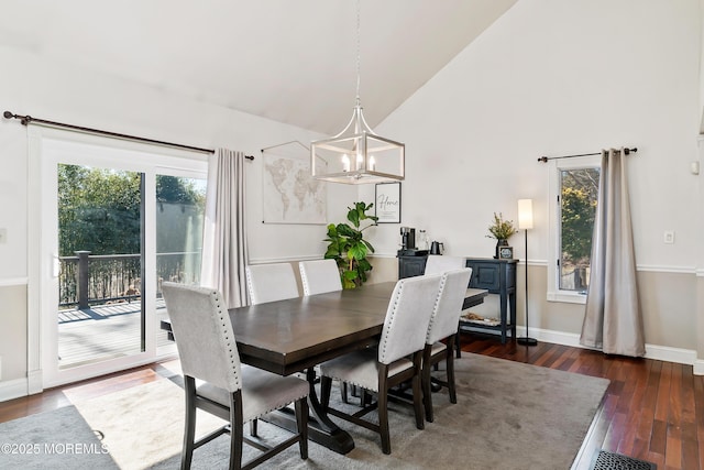 dining space featuring a chandelier, a healthy amount of sunlight, baseboards, and hardwood / wood-style flooring