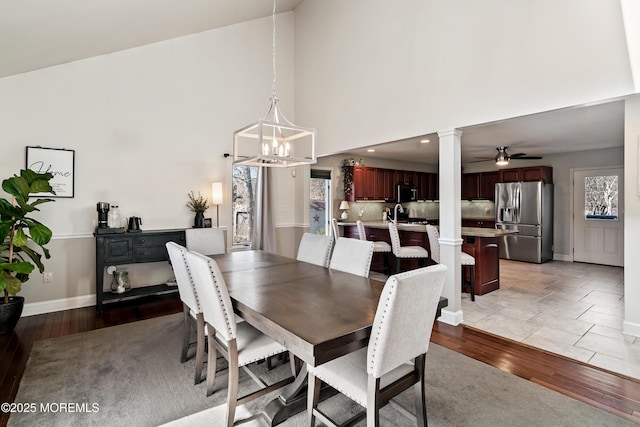 dining room with plenty of natural light, baseboards, and light wood-style flooring