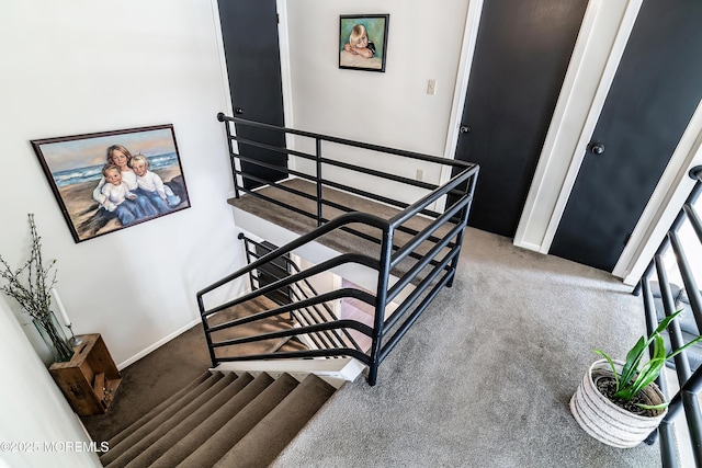 stairs with carpet floors and baseboards