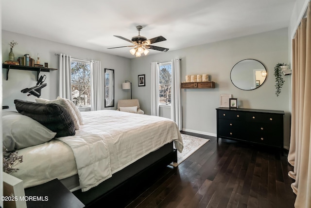 bedroom featuring a ceiling fan, baseboards, and dark wood-style flooring