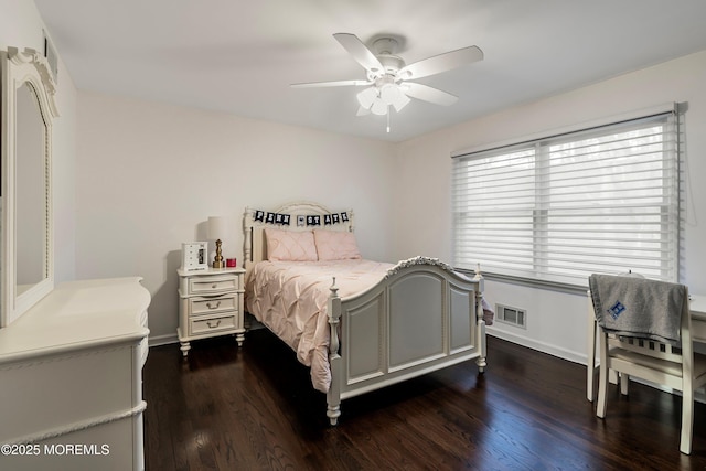 bedroom with dark wood-style floors, visible vents, ceiling fan, and baseboards