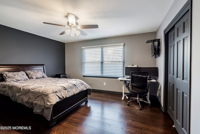 bedroom with ceiling fan, a closet, wood finished floors, and baseboards