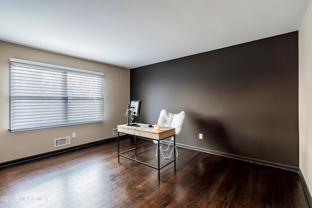 home office with dark wood-style floors, visible vents, and baseboards