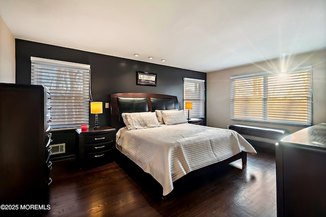 bedroom with dark wood-type flooring