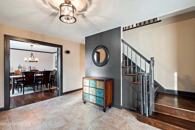 stairs featuring baseboards, tile patterned flooring, and an inviting chandelier