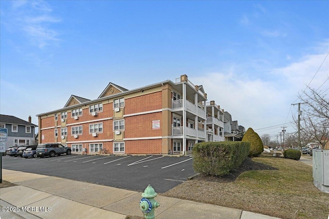 view of building exterior with uncovered parking