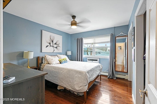 bedroom with dark wood-style floors, a baseboard radiator, and ceiling fan