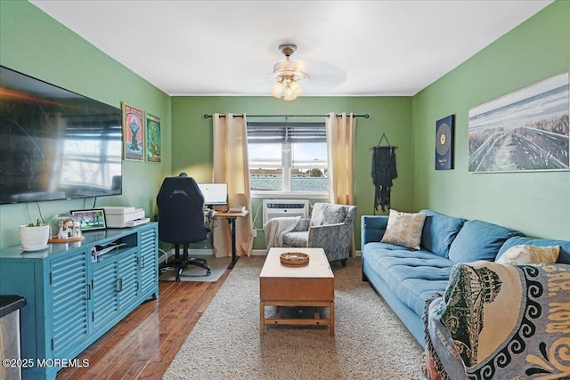 living area with a ceiling fan and wood finished floors