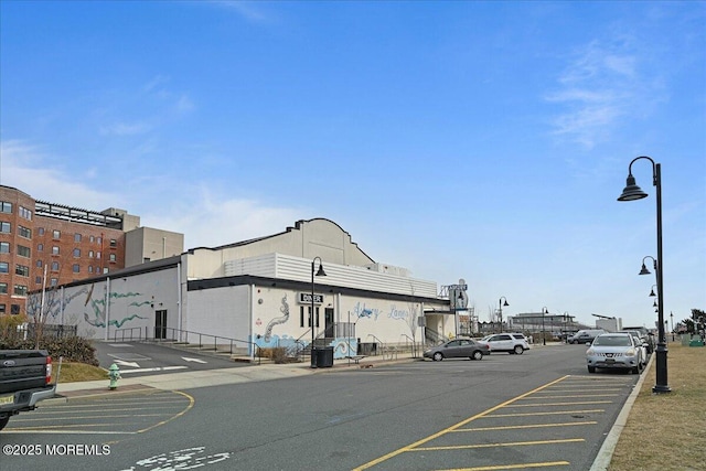 view of street featuring sidewalks, curbs, and street lights