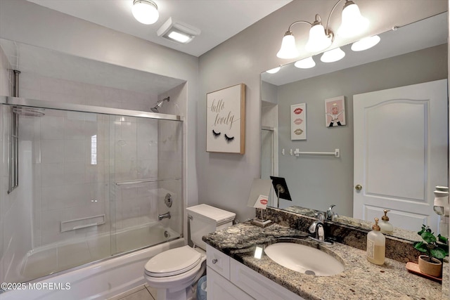 bathroom with toilet, enclosed tub / shower combo, and vanity