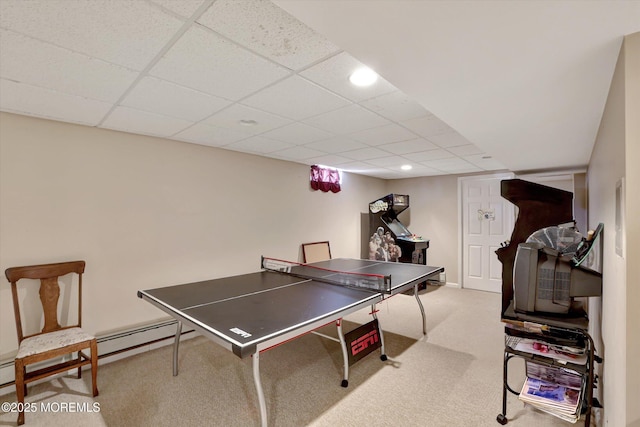 rec room with a baseboard heating unit, a drop ceiling, and carpet flooring