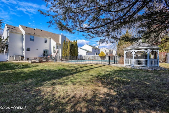 view of yard with a gazebo, a patio, fence, and a fenced in pool